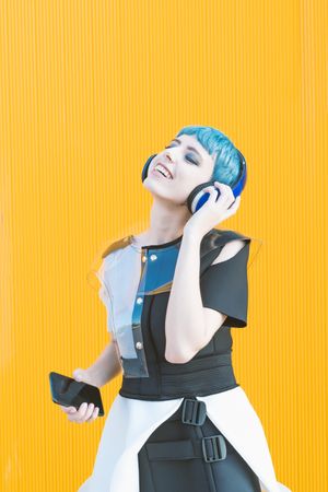 Futuristic woman using smartphone and listening to music