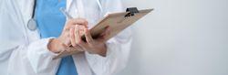 Doctor standing in bright hospital room with copy space, banner