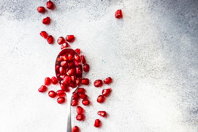 Spoon with pomegranate seeds