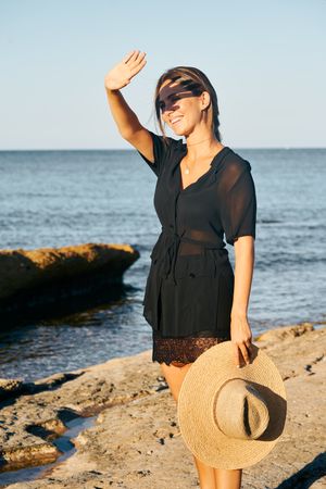 Calm woman enjoying sun on beach