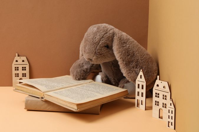 A children's book with toys on a beige background.