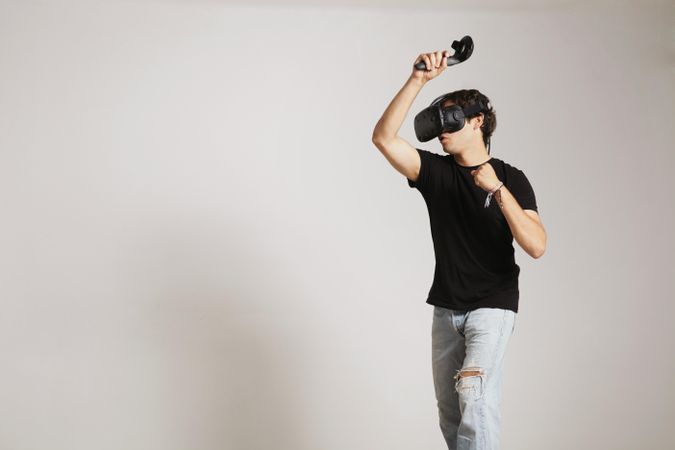 Man playing interactive game in VR headset