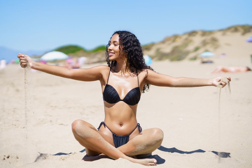 A Joyful Beach Moment A Woman Passionately Enjoying a Wonderful Day Under the Sun