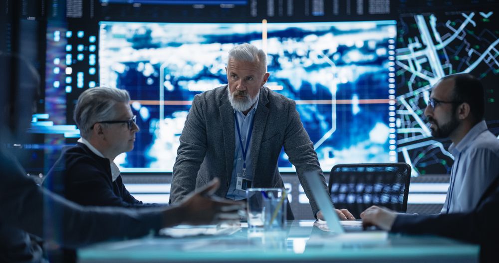 Diverse Group of Cybersecurity Experts Monitoring an Active Operation with Satellite Tracking Technology.