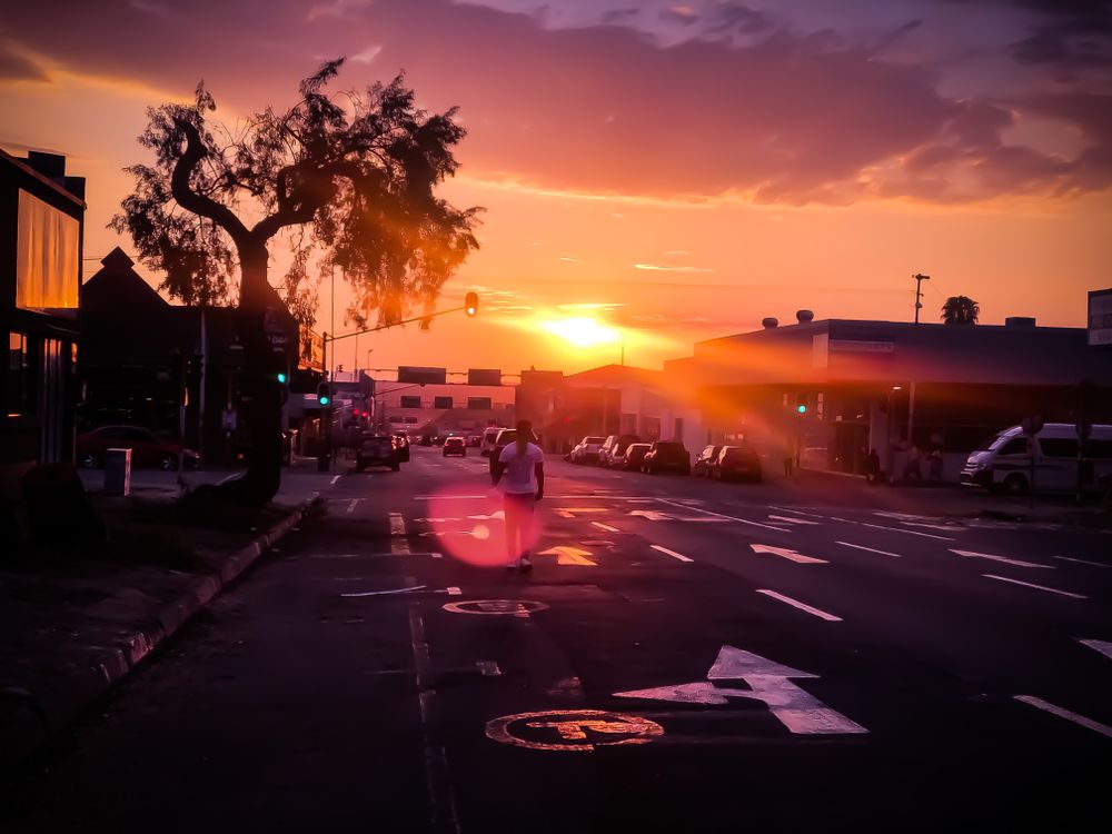 Man walking on road during sunset