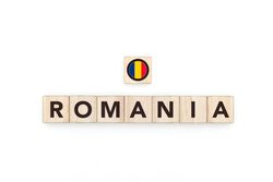 Wooden blocks bearing the name and flag of Romania. Romanian and East European Culture, national identity, travel, and geography in a copy space design.