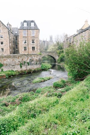 Aged stone buildings with green bushes around
