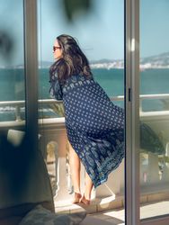 Woman standing on balcony near border in hotel