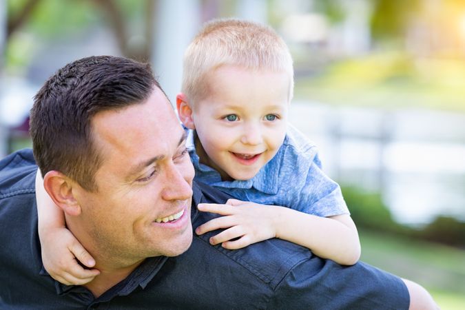 White Father and Son Having Fun At The Park