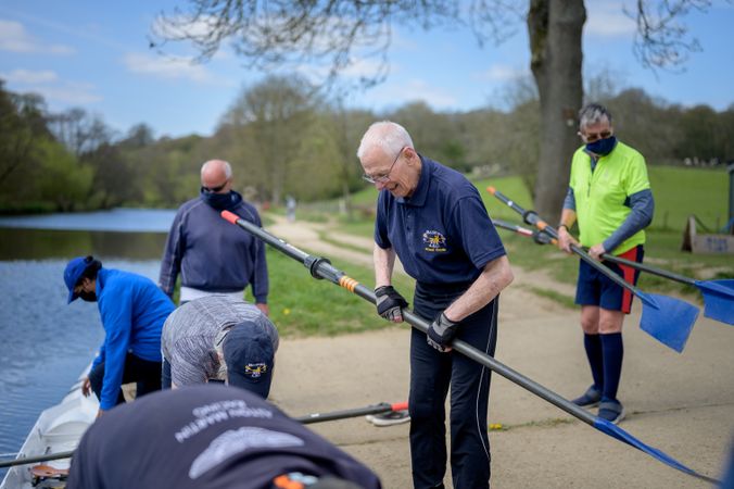 People preparing to row together