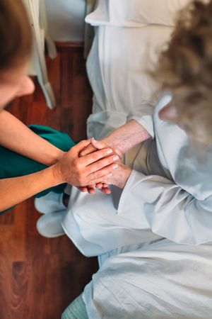 Doctor giving encouragement to older female patient