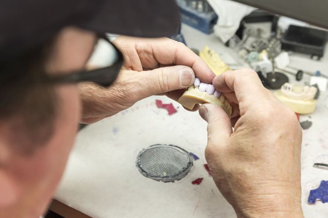 Dental Technician Working On 3D Printed Mold For Tooth Implants