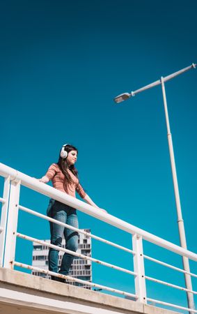 Teen girl watching the street while listening to music.