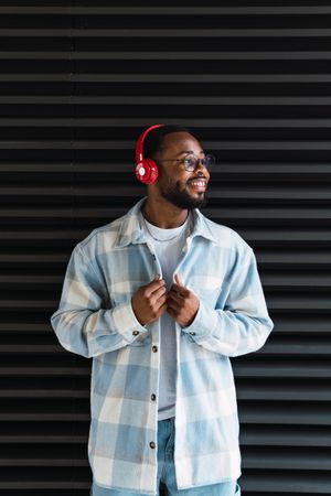 Smiling Black man in headphones and jacket