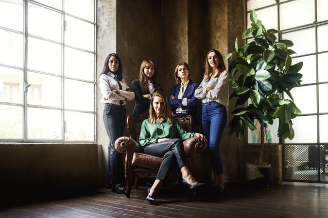 Group portrait of businesswomen looking at camera in creative office