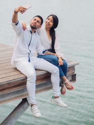 Woman with man taking photo selfie