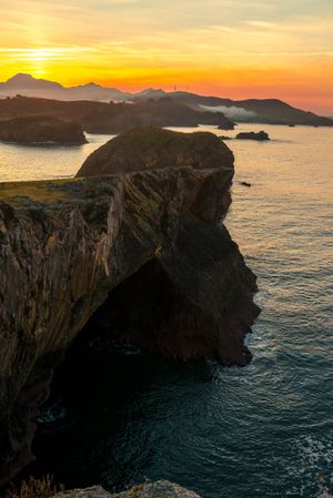 Majestic cliffs of ocean coastline in sunset