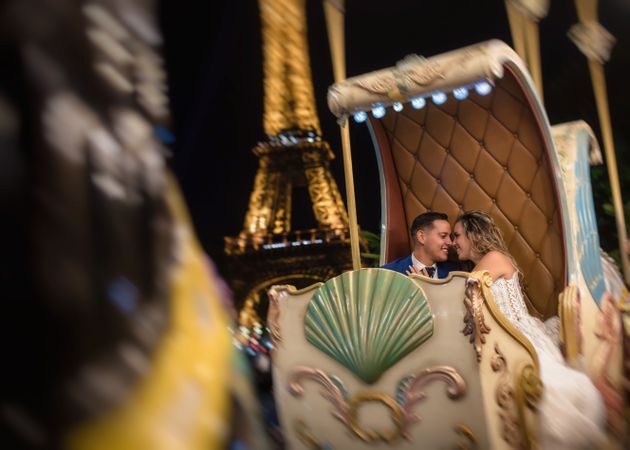 Just married couple in wedding suits taking amusement rides
