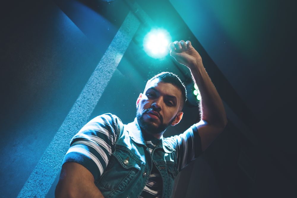 bearded man dancing in spotlight