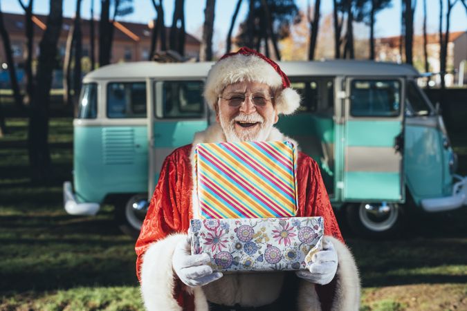 Santa Claus with presents by old van