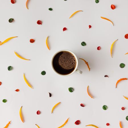 Bright colorful autumn pattern made of leaves, with coffee cup