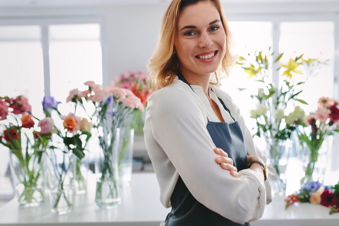 Portrait of happy and confident florist owner in her own flower shop