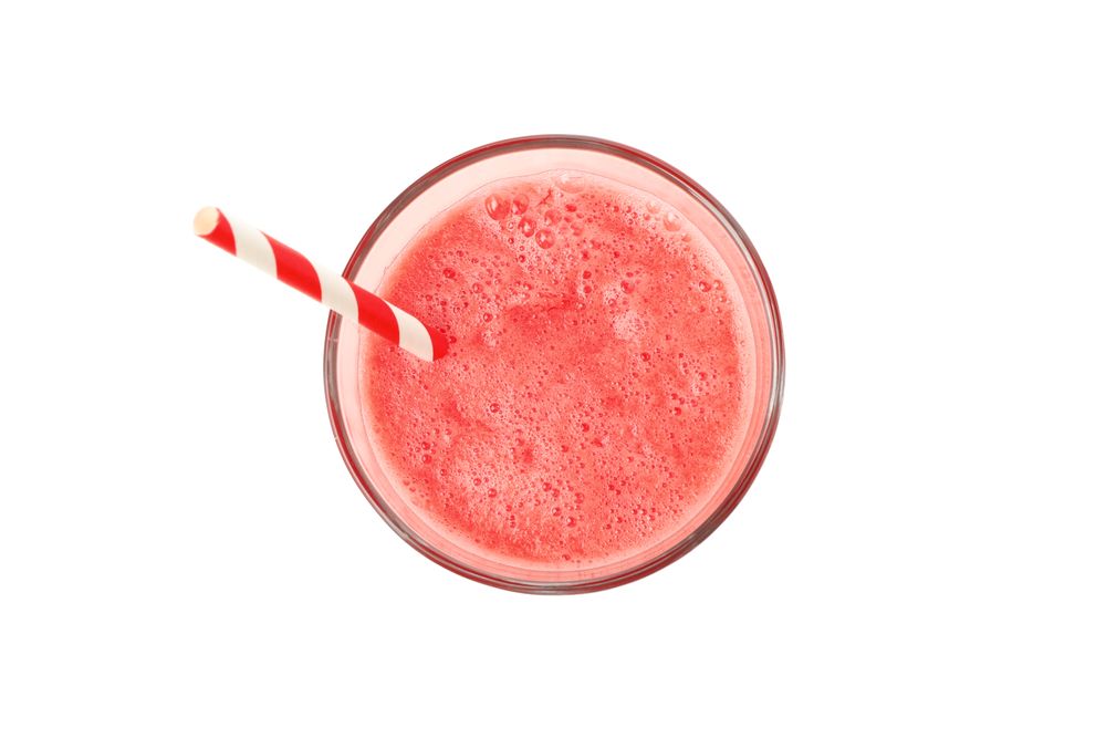 Glass of watermelon juice isolated on plain background. Fresh drink