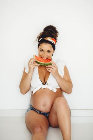 Pregnant female eating delicious watermelon
