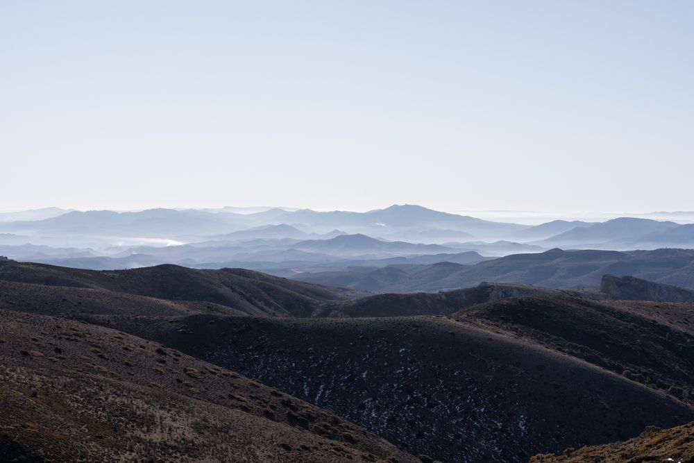 A landscape mountainous view with a lot of layers and deep of field and fog on the top