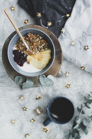 Smoothie bowl on wooden board with cup of tea