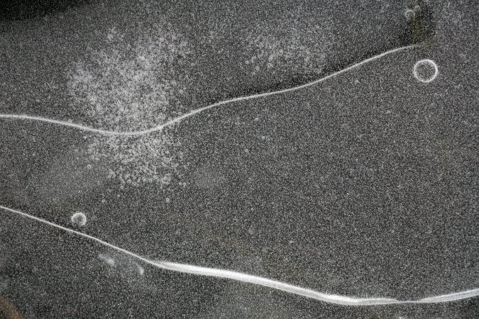 Fragment of thin ice on dark frozen river