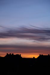 Colorful sky over French village at dawn, vertical