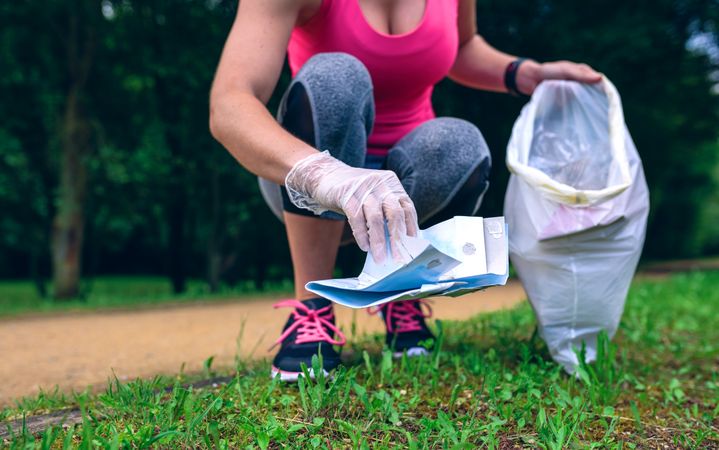 Woman picking up trash doing plogging
