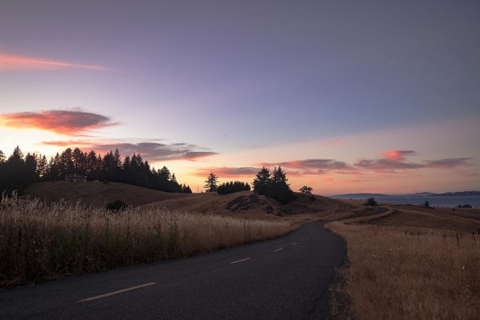 Road leading into the hills at sunset
