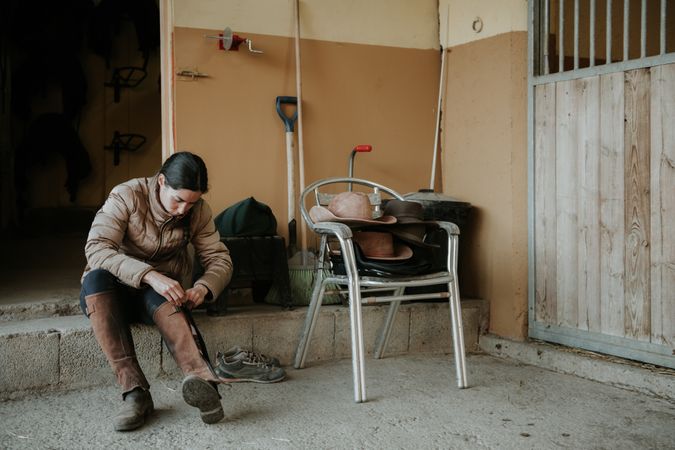 Woman preparing for horseback ride