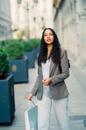 A Stylish Young Woman Enjoying Shopping in a Vibrant Urban Setting Full of Life and Fashion