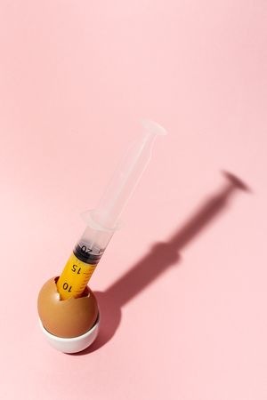 Egg with syringe in eggcup