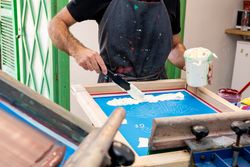Male artist creating print on t-shirt