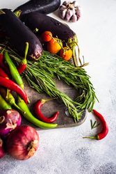 Fresh colorful vegetables and herbs on wooden board with copy space
