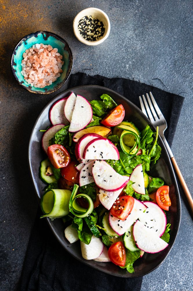 Plate of healthy vegetable salad on rustic background