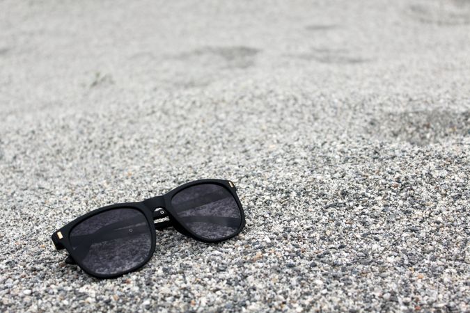 Sunglasses sitting on grey pebbles