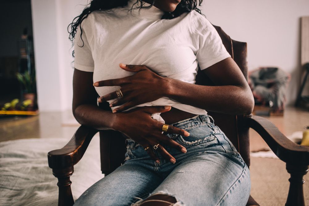 Black woman holding her stomach