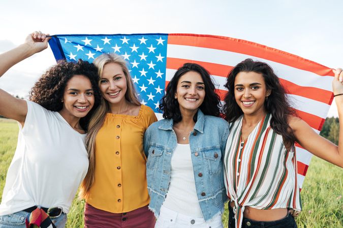 Group of multi-ethnic women holding a USA flag
