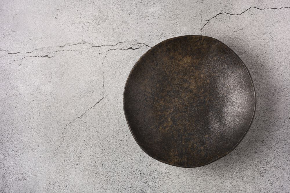 Empty plate on the slate table. Top view of the image.