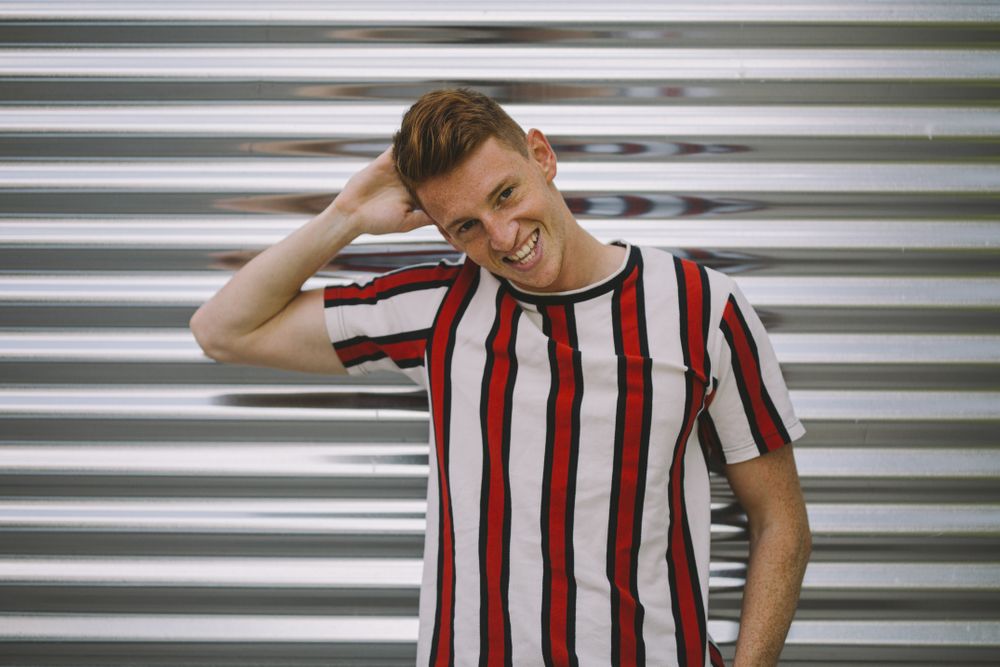Man leaning on steel garage door