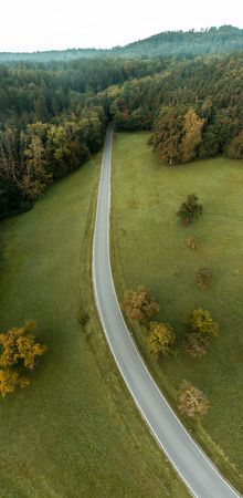 Drone aerial panorama with road passing through