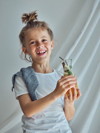 Happy boy with glass of lemonade