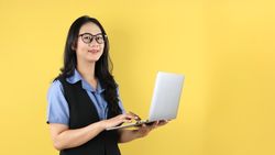 Young Asian Woman Standing and Holding Laptop
