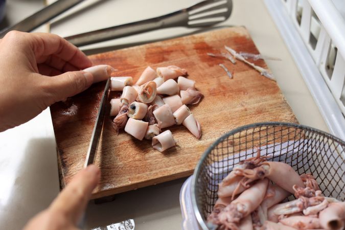 Female Hand Slicing Cumi Asin