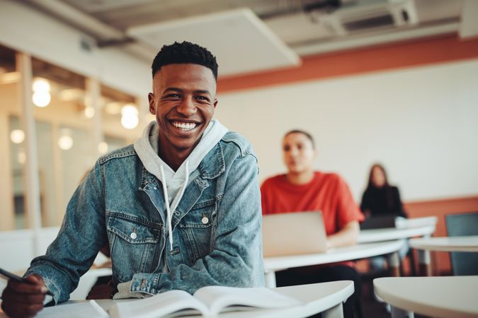 Happy Black student sitting in classroom
